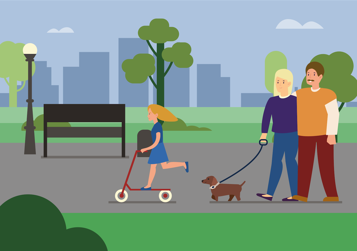 Couple walking through a park with their dog on a leash while their daughtr rides a scooter in front of them