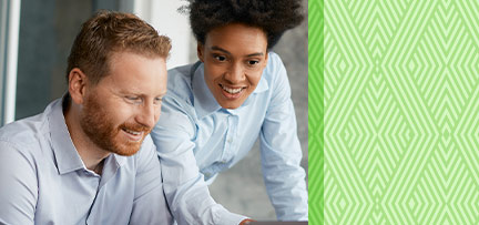 Two people looking at a computer 