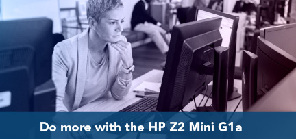 A person in an office working at a desktop computer 