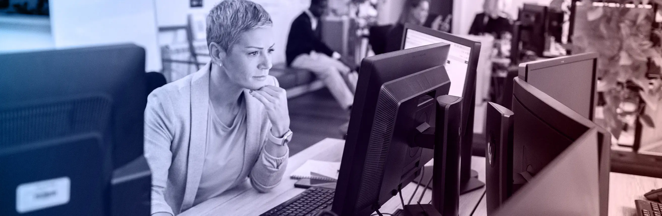 A woman in an office working in front of a monitor